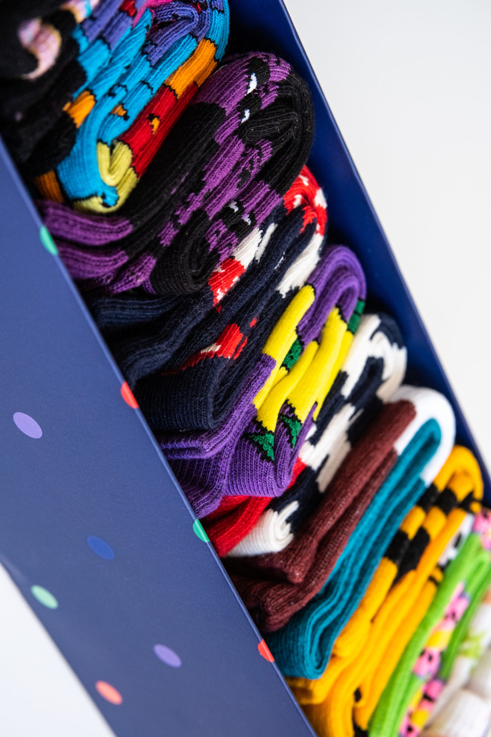 Several colorful cotton socks rolls in a box